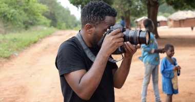 Mussa Uwitonze photographing in the field
