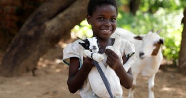 Omega (9) with her goat in Mchiliko, Nsanje. Photo: Jon Hozier-Byrne/Concern Worldwide
