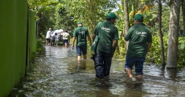 Concern Emergency response team members walk through a submerged road in Noakhali district following the 2024 Bangladesh floods. Photo: Akram Hossain/Concern Worldwide