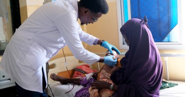 Doctor Muhammad Dek Jama treats Najma* (29) and her baby Cabdi* (18 months) at Banadir Hospital's Stabilisation Centre, Mogadishu. Photo: Hugh Golden/Concern Worldwide