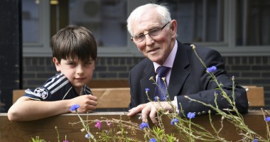 Young boy and Elderly man receive awards for their fundraising efforts 