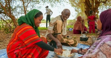 Concern Communications Officer Kalkidan Jabir shares a meal with Hussein Abdulahi Hussein and his wife Nadifa Yusuf and their family in Alloley Kebele, Dollo Bay District in the Somali Region of Ethiopia. Hussein leads a group of 45 farmers who are part of an agriculture group supported by the Hannano Programme. With this support, they received improved variety of seeds, a generator, fuel, water pumps, and training.