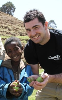 Smiling Apple Farmers, Father and son, Ebrie and Mohammed Ali Demsie with Rob Kearney showing their crops in Dessie Zuria, Ethiopia. Photo: Jennifer Nolan / Concern Worldwide