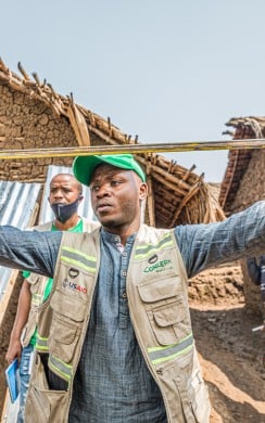 Concern staff check measurements of latrines