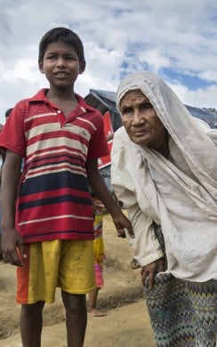 Young boy and grandmother in Rohingya refugee camp, Bangladesh