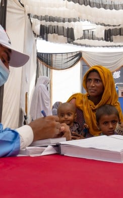 Sughraan and her family consult with a medical staff member at the free medical camp