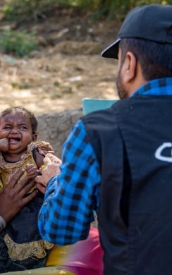 Concern staff examines baby Radhika in Pakistan