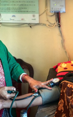 Sathi Rani, a community health care provider, is attending a beneficiary, Rahima Begum,