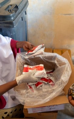 Ayan* (39) receives a supply of RUTF, for her 18 month old child Ahmed*, from the health worker at the Wiil Waal health centre.