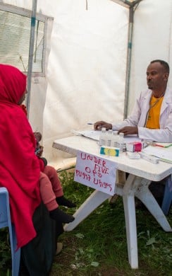 Health officer Fentaw Said attends to a patient in Atintmesberia mobile health clinic