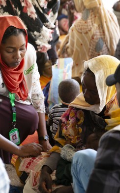 Concern Health and Nutrition Officer, Yamen Nassir, with Salwa Abaker and baby Adan at Ardamata Health Centre in West Darfur, Sudan.