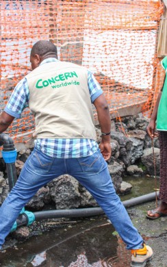 Staff in Democratic Republic of Congo clean tanks at the water pumping station built and maintained by Concern at a displacement site in North Kivu. Photo