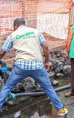 Staff in Democratic Republic of Congo clean tanks at the water pumping station built and maintained by Concern at a displacement site in North Kivu. Photo