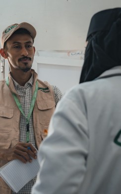 Concern Health and Nutrition Officer Saleh Hassan discusses the IEC materials with midwife Waseefa during a routine monitoring visit to the Concern supported health clinic 