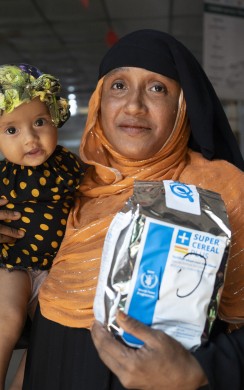 Asmida* , a 35-year-old Rohingya mother, with her child