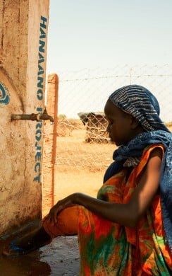 Binta Feriagmed collecting water from tank