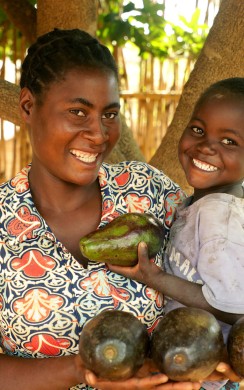 Memory and her son Steven hold avocados