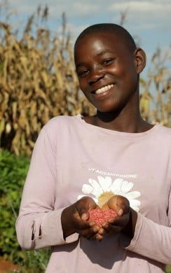 Naomi Frank holding seeds provided by Concern