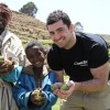 Smiling Apple Farmers, Father and son, Ebrie and Mohammed Ali Demsie with Rob Kearney showing their crops in Dessie Zuria, Ethiopia. Photo: Jennifer Nolan / Concern Worldwide