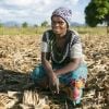 Farmer in Malawi sitting on her land, prepared using Climate Smart Agriculture techniques 