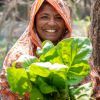 Asma  from Bangladesh shows off produce she has grown since participating in Climate Smart Agriculture training with Concern.