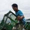 Filipino fisherman Jonel on the boat he received from Concern following Typhoon Haiyan