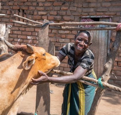 Farmer Malita Jeke with her cow that she bought with money from Concern Worldwide