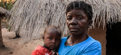  Caustasie Kisoke Mukala, 61, and her grandchildren Gloria and Emmanuel, outside their home in Manono.