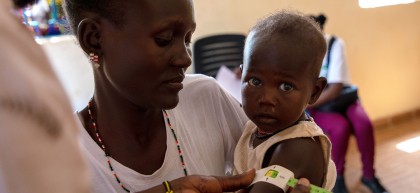 Concern staff members meet Everlyn Ekiru and her one-year-old Josephine at the local health clinic at Loiyangalani. Photo: Gavin Douglas/Concern Worldwide