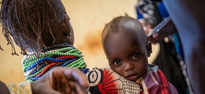 African child holding onto older sister