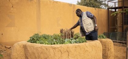 Boubarcar Abdulaye, a Concern staff member, tends to keyhole garden surrounded by clay walls