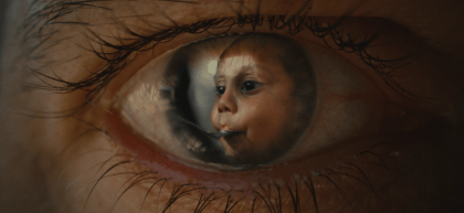 Child reflected in person's eye