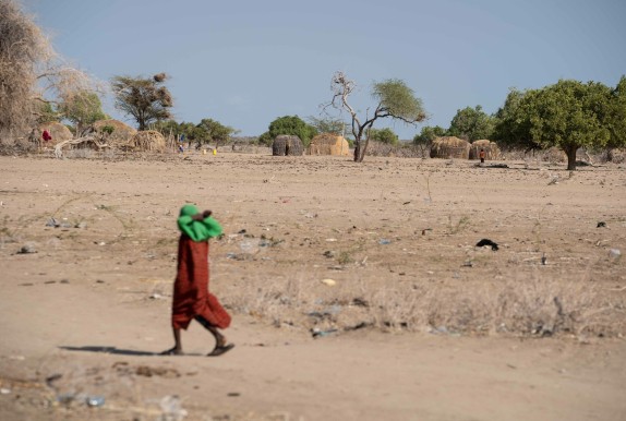 Child walking across desert land