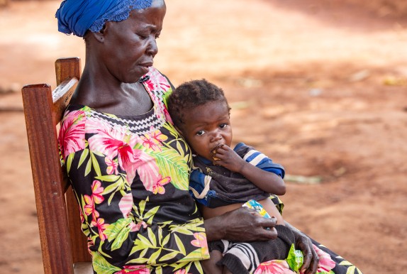 Dominique* holds her orphaned grandchild Sylvie*