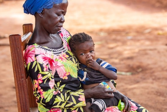 Dominique* holds her orphaned grandchild Sylvie*