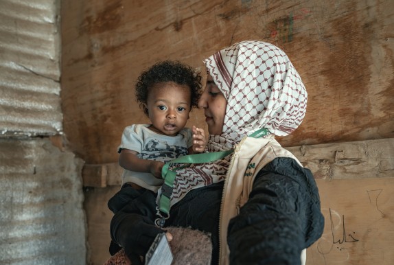 Concern health worker holding baby Basam