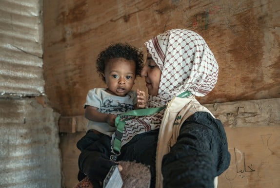Concern health worker holding baby Basam