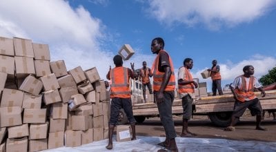 A team of locally hired workers unload a truck carrying supplies in Ndeja, Mozambique. Photo: Tommy Trenchard / Concern Worldwide.