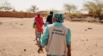 Three women walking in Niger with backs to camera