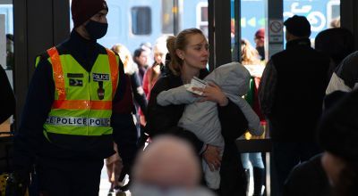 Woman carrying child into train station