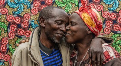Congolese couple against a colorful background