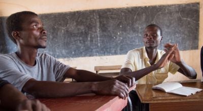 Malawian men meeting in a schoolroom