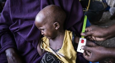 Child being measured for malnutrition