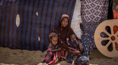 Naima* with her children outside their hut at in an IDP site in Somalia. Photo: Mustafa Saeed