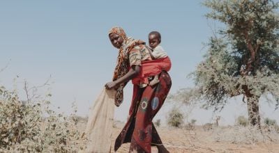 Nigerien woman and her daughter prepare a field for rainy season
