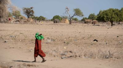 Child walking across desert land