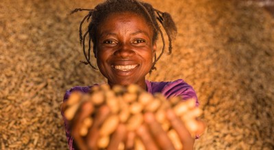 Congolese woman with the harvests from her peanut farm