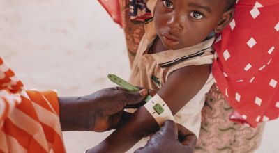 A child in Niger having their mid-upper arm circumference measured to screen for malnutrition