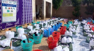Rows of buckets, water cans and hygiene supplies