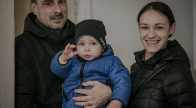 A couple and their young son at a local hub in Ukraine
